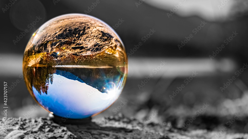 Crystal ball alpine landscape shot with black and white background outside the sphere at the famous Hintersee near Ramsau, Berchtesgaden, Bavaria, Germany Crystal ball alpine landscape shot with black and white background outside the sphere at the famous Hintersee near Ramsau, Berchtesgaden, Bavaria, Germany