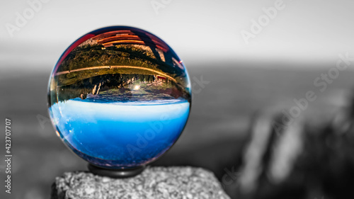 Crystal ball alpine landscape shot with black and white background outside the sphere at the famous Kampenwand, Aschau im Chiemgau, Bavaria, Germany © Martin Erdniss