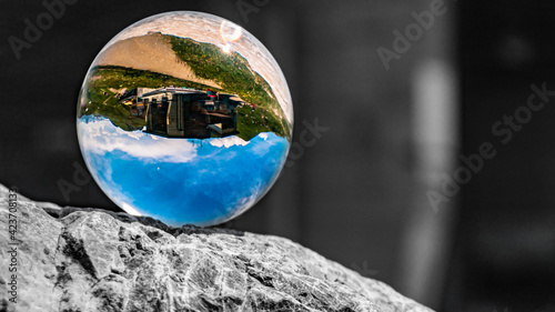 Crystal ball alpine landscape shot with black and white background outside the sphere at the famous Nebelhorn summit near Oberstdorf, Bavaria, Germany