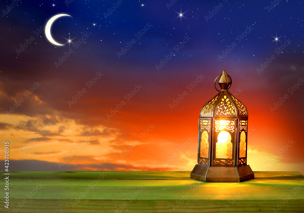 Islamic greeting Eid Mubarak card for Muslim  festival   Kareem background. Lantern lightning on wooden table.  Stock Illustration | Adobe Stock