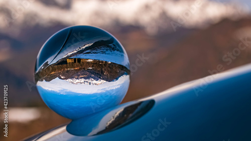 Crystal ball alpine landscape shot with black and white background outside the sphere at the famous Rossfeldstrasse near Berchtesgaden, Bavaria, Germany