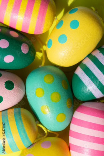 colorful painted easter eggs on yellow background