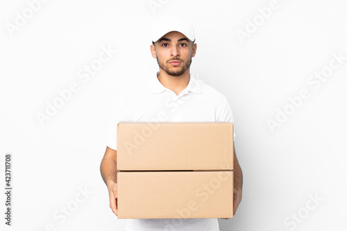 Delivery Arabian man isolated on blue background keeping arms crossed