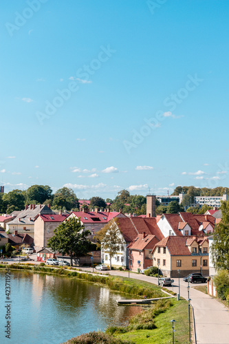 Old buildings by the Lake of Talsi in the old town of Talsi, Latvia during sunny summer day