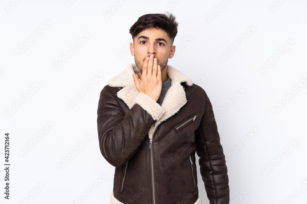 Arabian handsome man over isolated background covering mouth with hand Arabian handsome man over isolated background covering mouth with hand