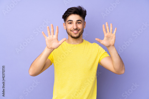 Arabian handsome man over isolated background counting ten with fingers