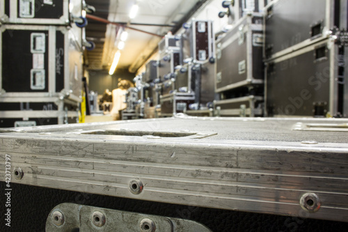 Protective flight cases on wheels in warehouse storage zone. Backstage with empty flight cases from concert equipment.