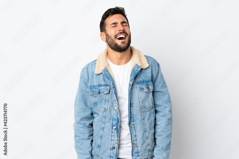 Young handsome man with beard isolated on white background laughing