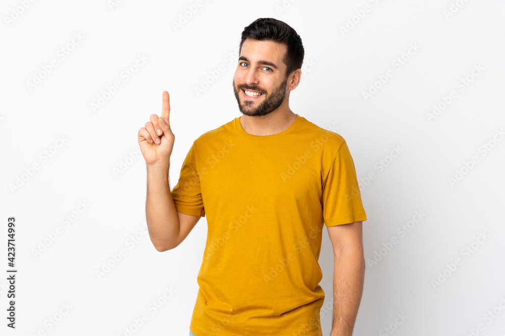 Young handsome man with beard isolated on white background showing and lifting a finger in sign of the best Young handsome man with beard isolated on white background showing and lifting a finger in sign of the best