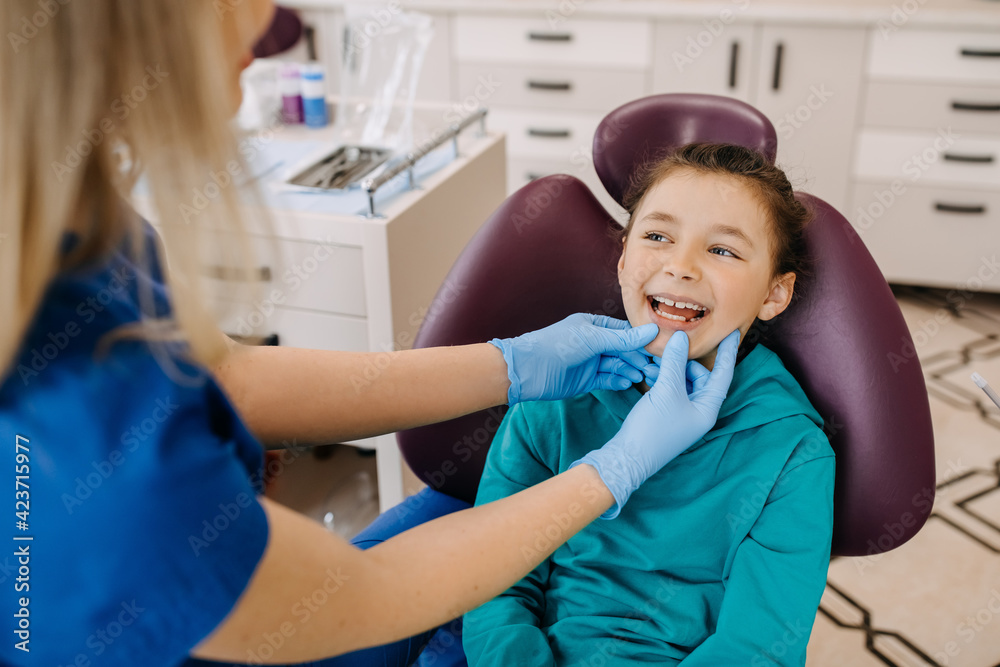 Child at a dental clinic at a checkup, smiling. Patient at a dentist. Child at a dental clinic at a checkup, smiling. Patient at a dentist.