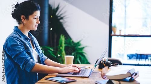 Slika na platnu Caucasian photographer working with media files on modern laptop computer using