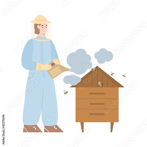 Beekeeper at apiary with smoker pollinates bees and hive by smoke for take honey