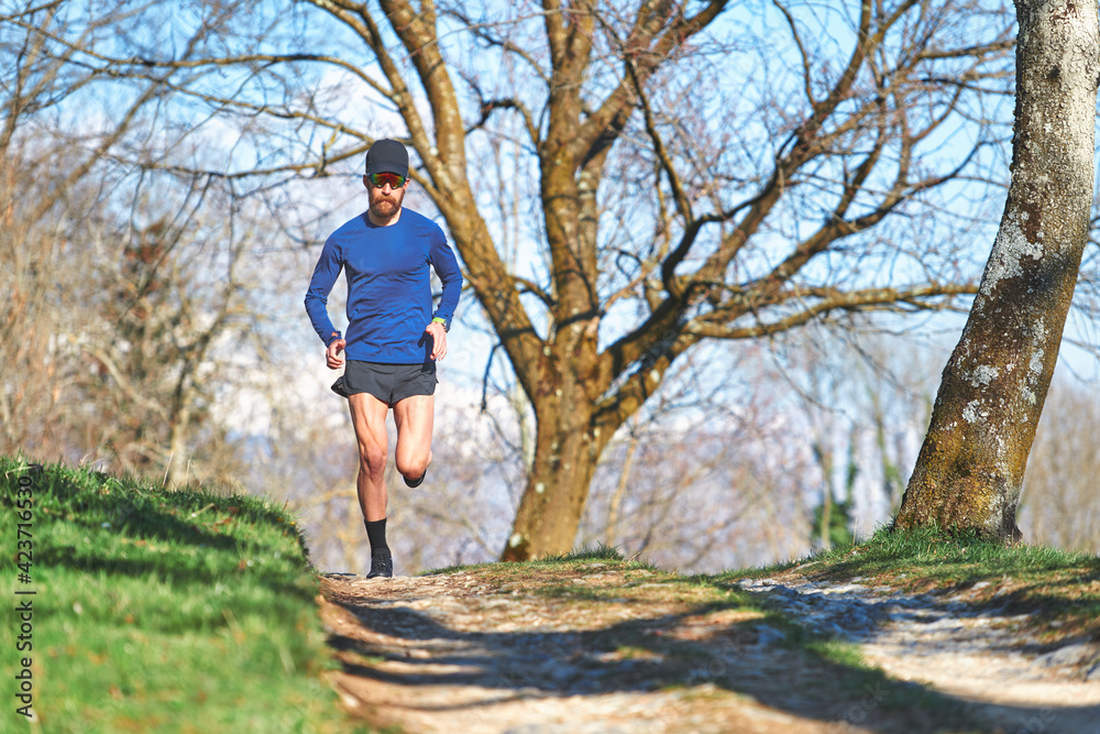 Ultra marathon man athlete during a hill workout Ultra marathon man athlete during a hill workout