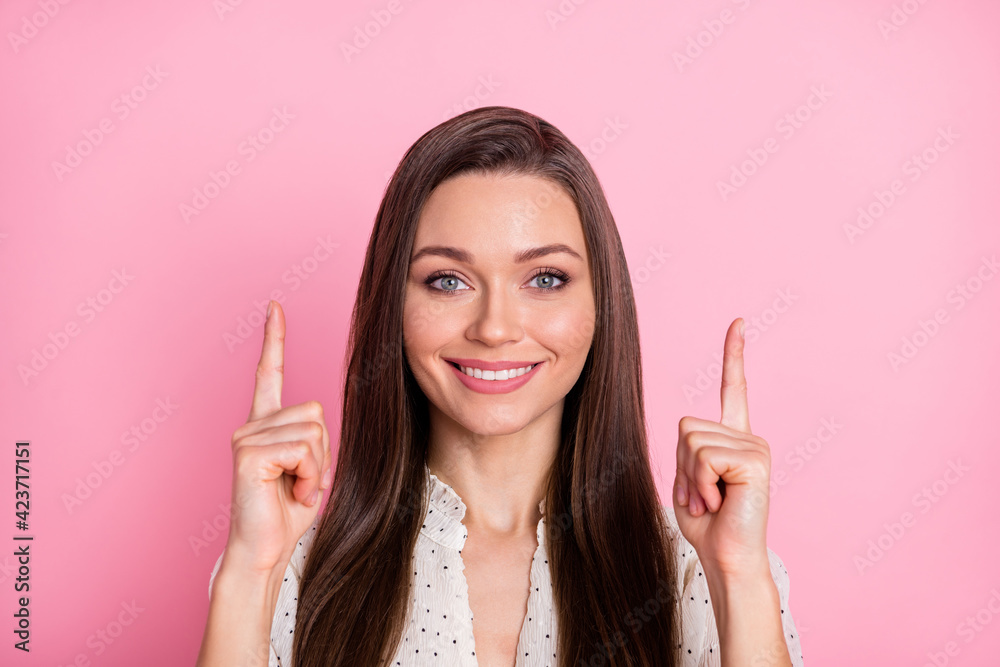 Close up photo of pretty cheerful lady indicate two fingers up empty space isolated on pink color background Close up photo of pretty cheerful lady indicate two fingers up empty space isolated on pink color background
