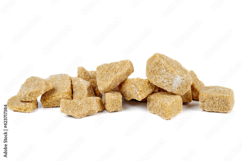 Pile of pieces of cane sugar isolated on white Pile of pieces of cane sugar isolated on white