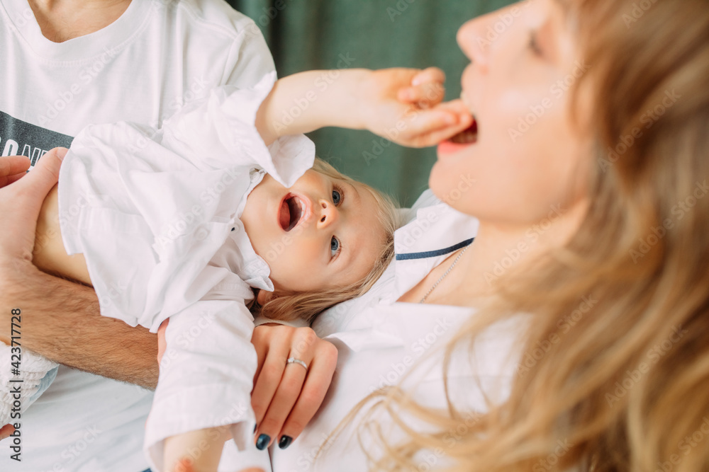 Parents have fun and play with their little son. Parents have fun and play with their little son.