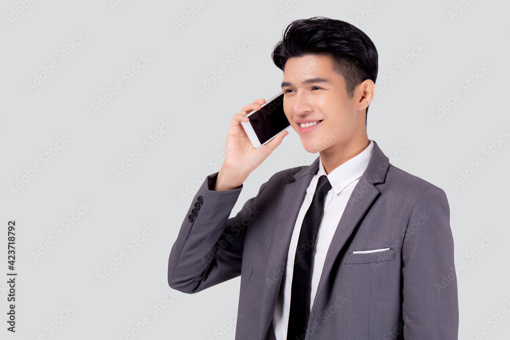 Young asian business man in suit talking on mobile phone isolated on white background, businessman speaking and listening smartphone with conversation, male holding cell phone, communication concept. Young asian business man in suit talking on mobile phone isolated on white background, businessman speaking and listening smartphone with conversation, male holding cell phone, communication concept.