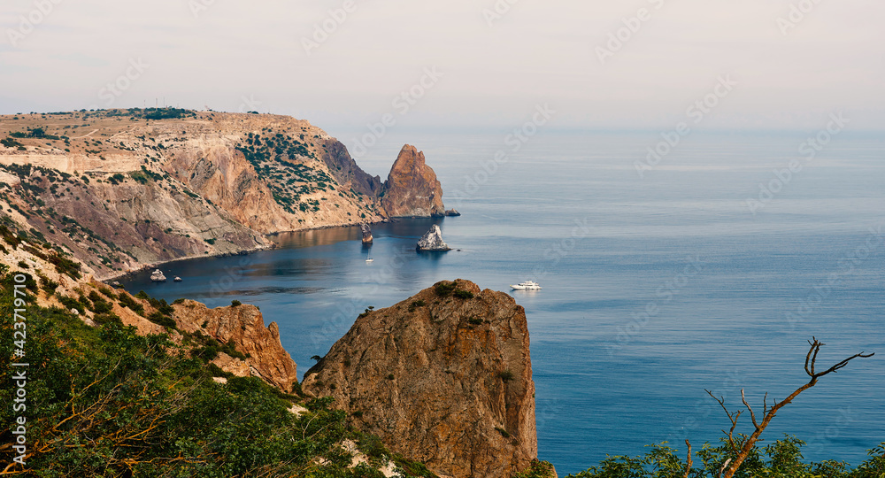Serene ocean and cliff at sunrise with copy space.