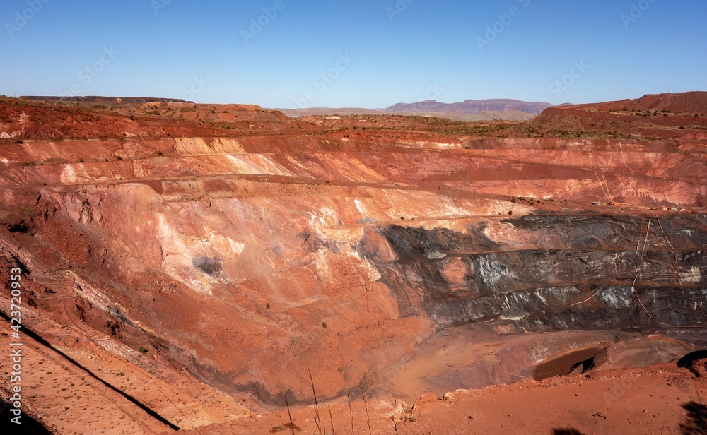 Deep pit of red iron ore mine in Pilbara region in Western Australia