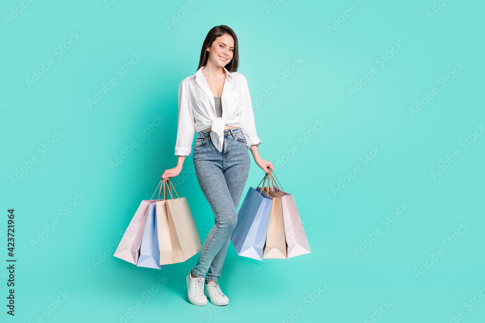Photo of cute sweet young woman dressed white shirt smiling shopping empty space isolated teal color background Photo of cute sweet young woman dressed white shirt smiling shopping empty space isolated teal color background