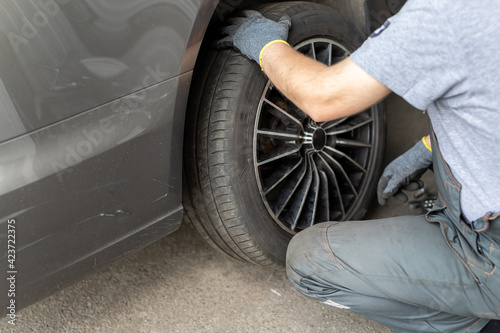 Car wheel repair shop outdoor ground . Seasonal winter tyre change at workshop. Vehicle tire repair, inspection and maintenance. Automotive garage for replace spare parts after failure breakdown