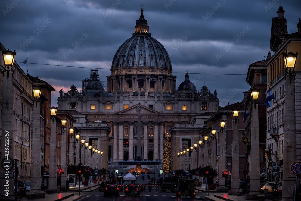 
Street with burning lanterns and St. Peter's Cathedral at night. Rome. Italy
