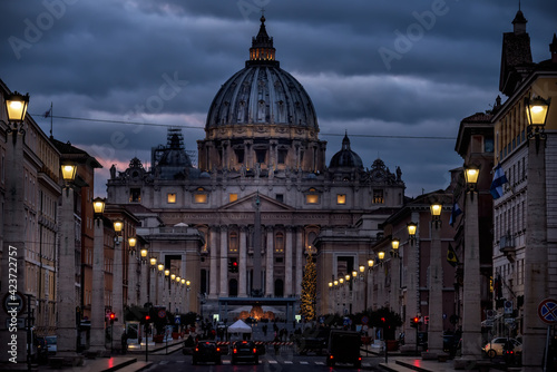  Street with burning lanterns and St. Peter's Cathedral at night. Rome. Italy