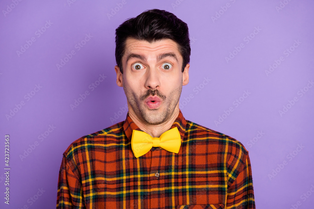 Fototapeta premium Photo of shocked amazed guy open mouth look camera wear bow tie plaid shirt isolated violet background