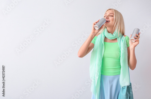 Beautiful young woman drink...