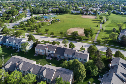 An aerial of a playground, baseball fields and tennis courts in the suburban neighborhood of Palatine, Illinois in summer.
