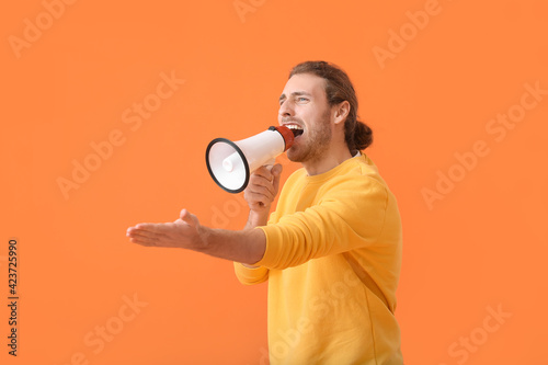 Young man with megaphone on...