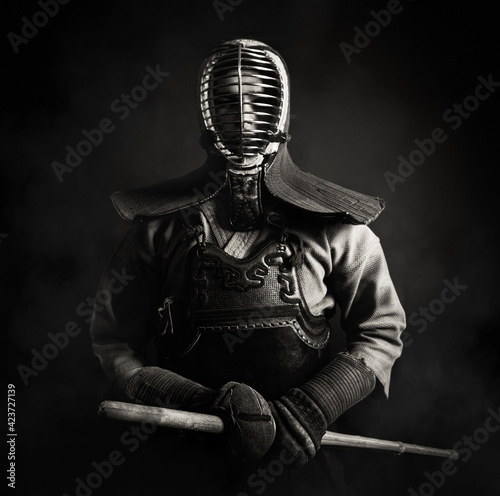 Portrait of Kendo master standing in fighting stance.