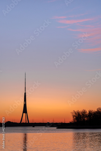 The tallest tower in the European Union - Radio and TV tower in Riga, Latvia during colorful sunrise over the Daugava river © Janis Eglins
