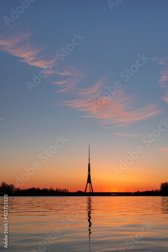 The tallest tower in the European Union - Radio and TV tower in Riga, Latvia during colorful sunrise over the Daugava river © Janis Eglins