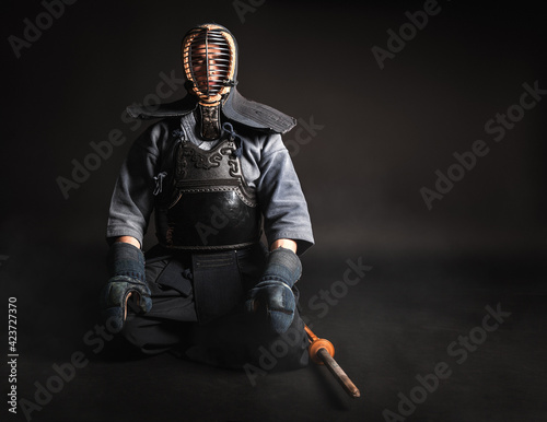Portrait of Kendo master sitting and preparing for fight.