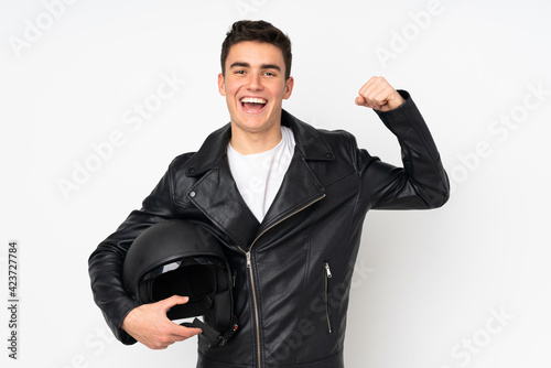 Man holding a motorcycle helmet isolated on white background making strong gesture