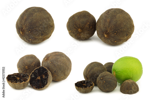Dried "black lime"fruit and some cut ones and a fresh one on a white background