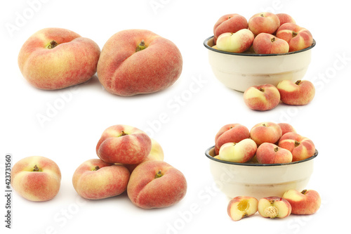  fresh colorful flat peaches (donut peaches) and some in an enamel bowl on a white background