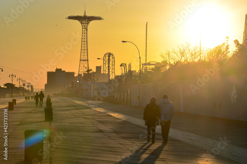 Coney Island famous board walk with setting sun  photo