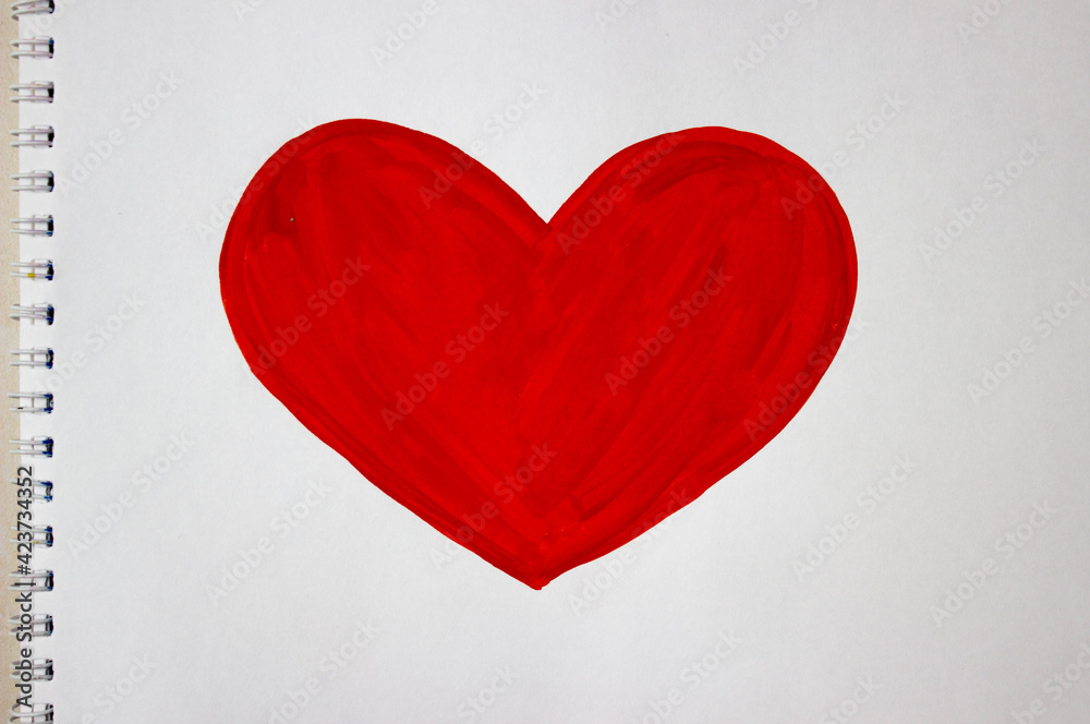 Fototapeta premium Heart drawing with red colors on a white album sheet. Close up photo