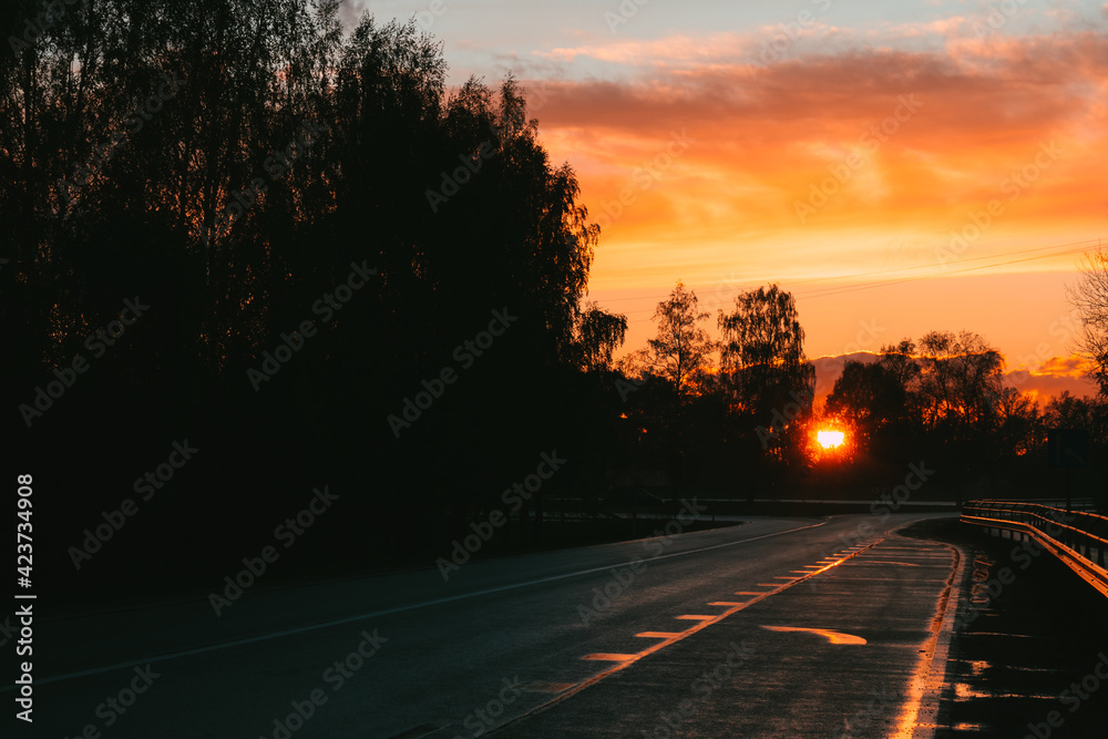Colorful sunset on the highway. Dark, moody and calm