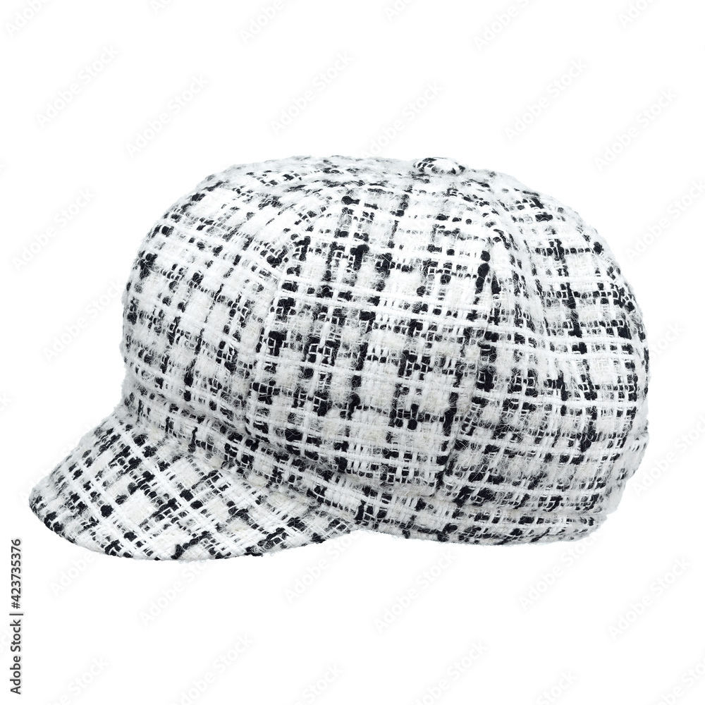 Fototapeta premium Women's cap with a visor, made of white and black wool yarn of the highest quality, isolated on a white background. Side view.