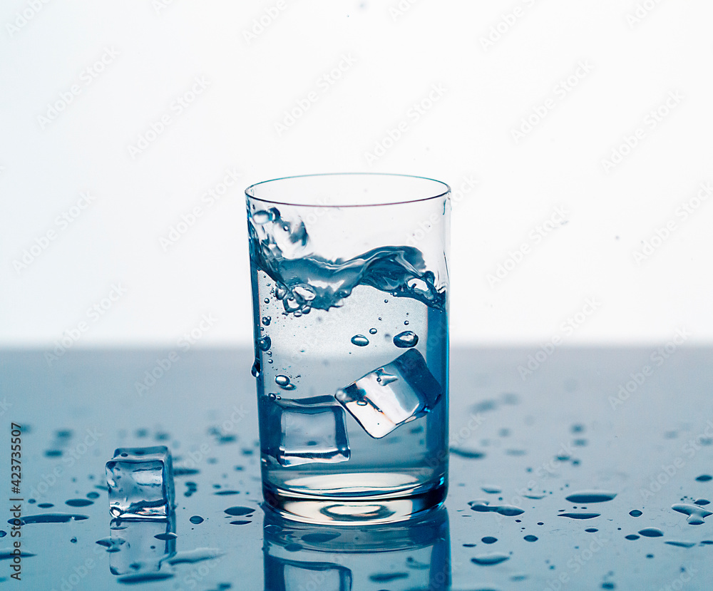 clear water spray in a glass with ice, clear water in a glass with spray clear water spray in a glass with ice, clear water in a glass with spray