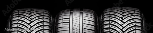 summer and all-season tires, front view tread on black background photo