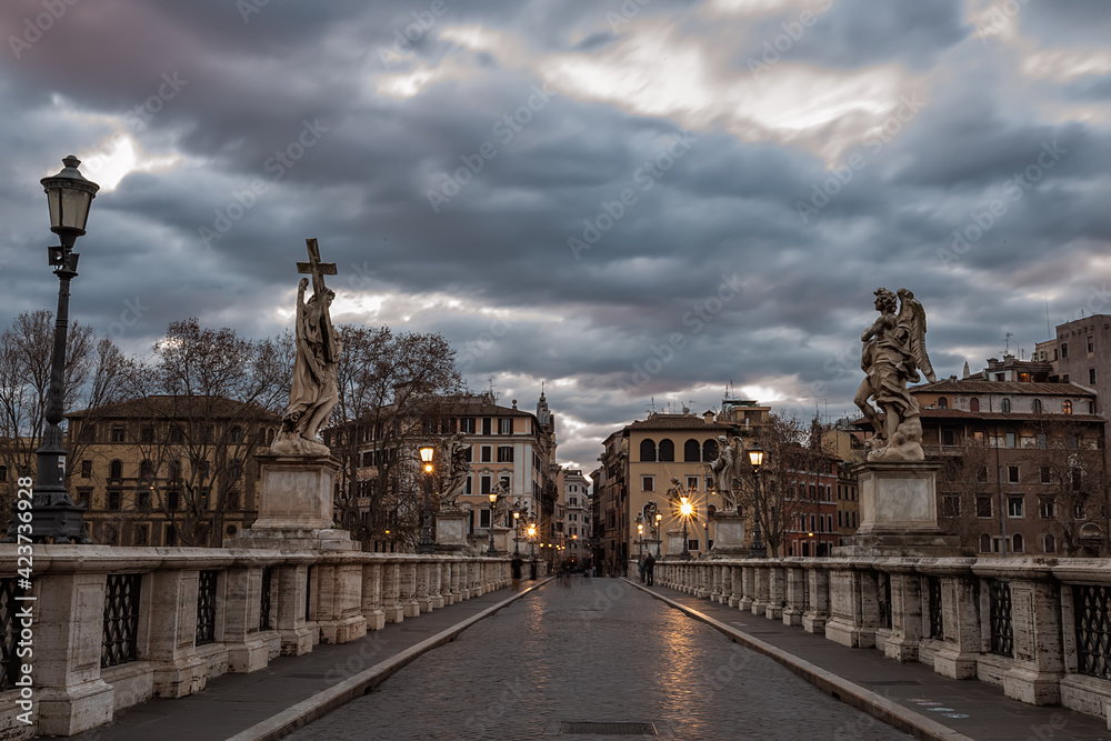 Eliev Bridge and the streets of Rome in the predawn time. Long exposure and blurry clouds in the dawn sky. Rome. Italy.