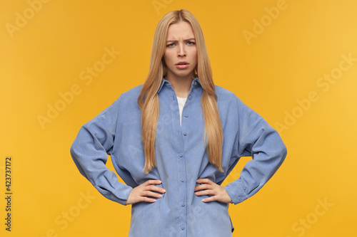 Фотография Frowning girl, discontent looking woman with blond long hair