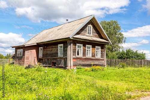 Old rural wooden houses in abandoned russian village in summer sunny day