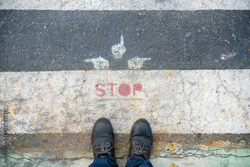 Safety sign for persons to stop before crossing the road by point the finger to make sure that right, left and in front of  it is safe before crossing.
