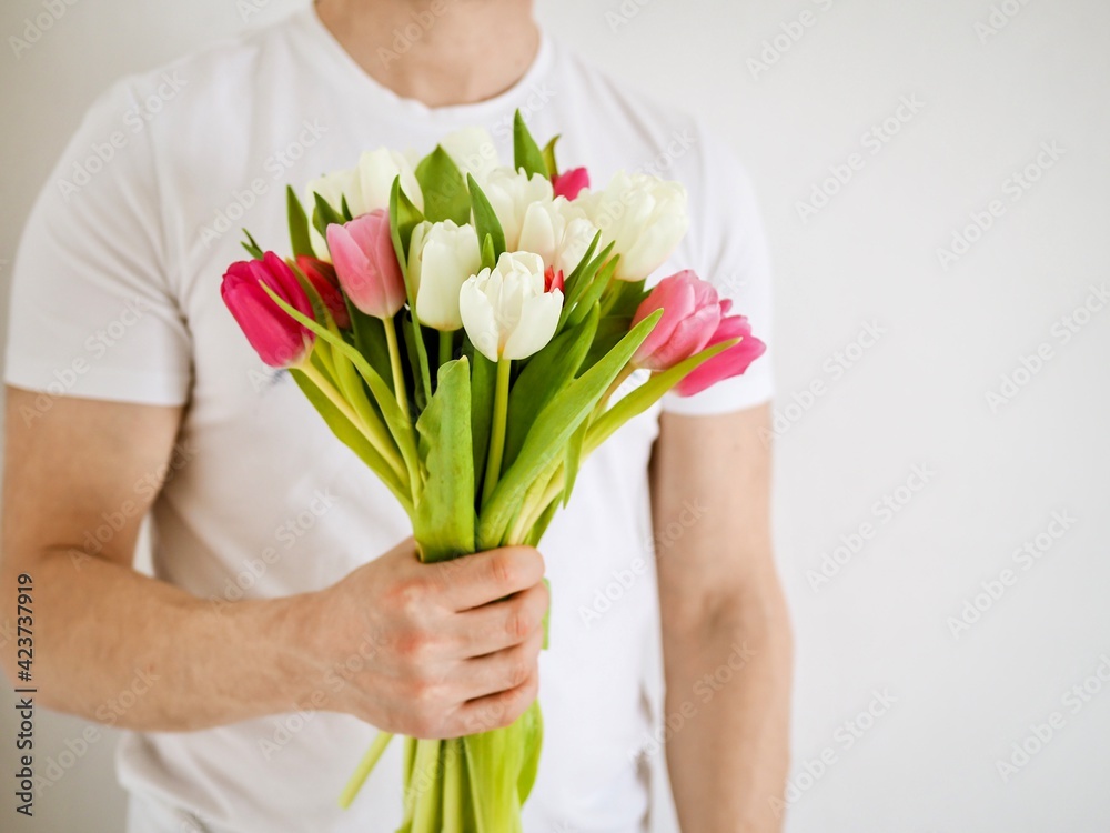 Man holding beautiful bouquet of colorful tulips. Fresh spring flowers. Valentine's Day, Women's Day, Mother's Day. Wedding concept. Spring cards. Copy space