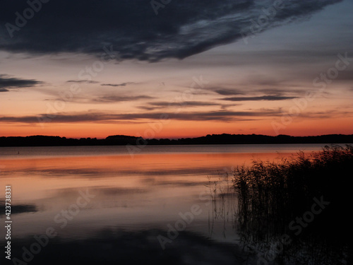 beautilful sunset with clouds and grass baltic sea © Tina